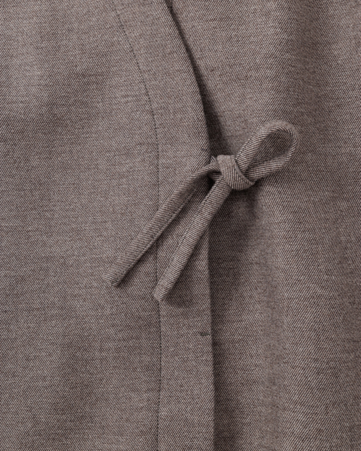 Close-up of a taupe-brown fabric with a tie detail