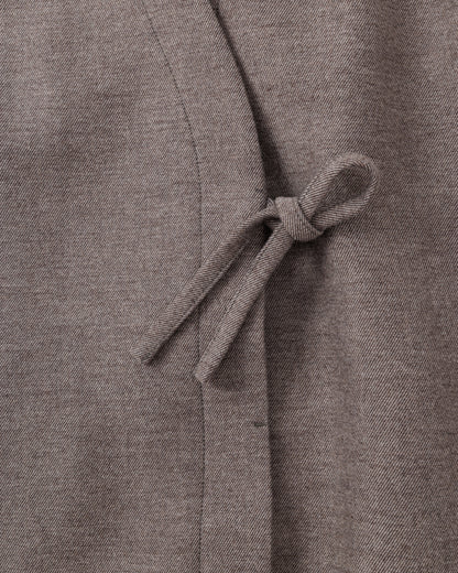 Close-up of a taupe-brown fabric with a tie detail