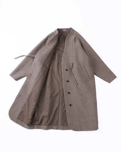 Taupe-brown coat with buttons on a white background