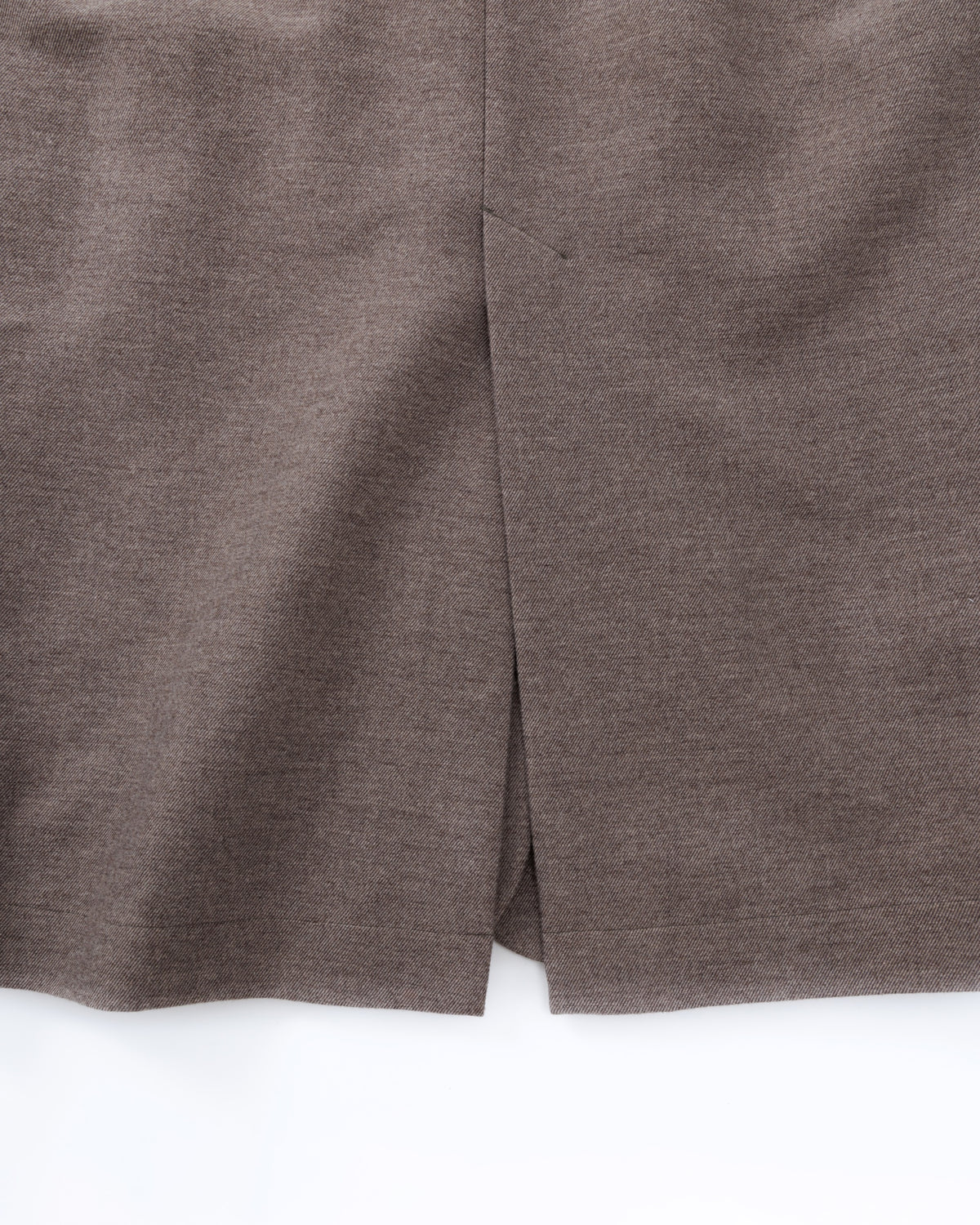 Close-up of a taupe-brown coat on a white background