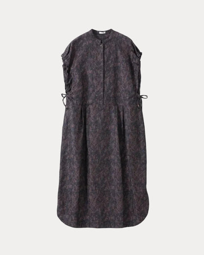 A sleeveless dark dress with an abstract mottled pattern in black and deep purple, featuring a buttoned front placket, gathered side details with drawstrings, and a flared silhouette, shown against a light grey background.