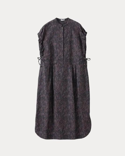 A sleeveless dark dress with an abstract mottled pattern in black and deep purple, featuring a buttoned front placket, gathered side details with drawstrings, and a flared silhouette, shown against a light grey background.
