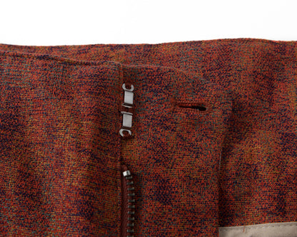 Close-up of a textured fabric with a zipper on a white background