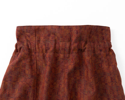 Red patterned trousers on a white background