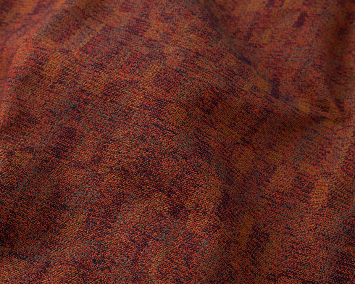 Close-up of red textured fabric with a subtle pattern