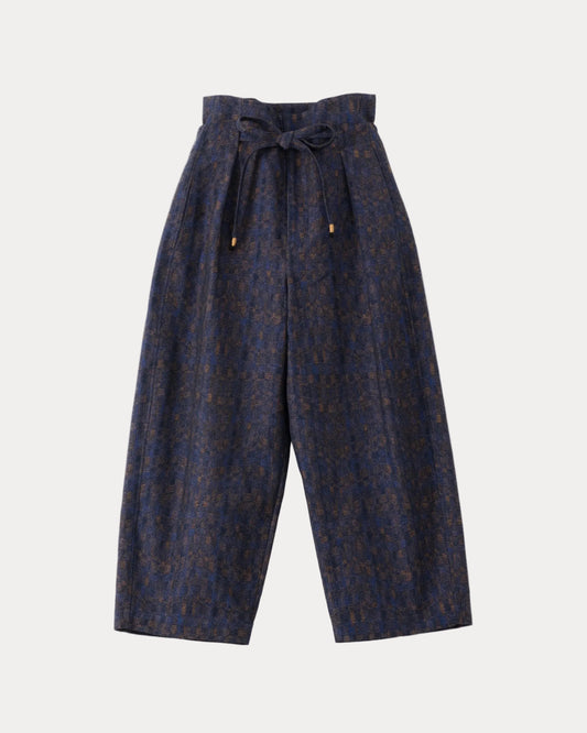 A pair of high-waisted, wide-leg cropped trousers in a dark navy blue and brown patterned fabric, featuring a matching waistband tie belt with small gold-toned hardware, shown against a light grey background.