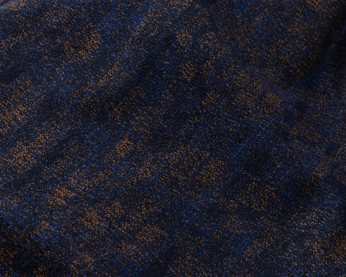 Close-up of a textured blue fabric with a subtle pattern