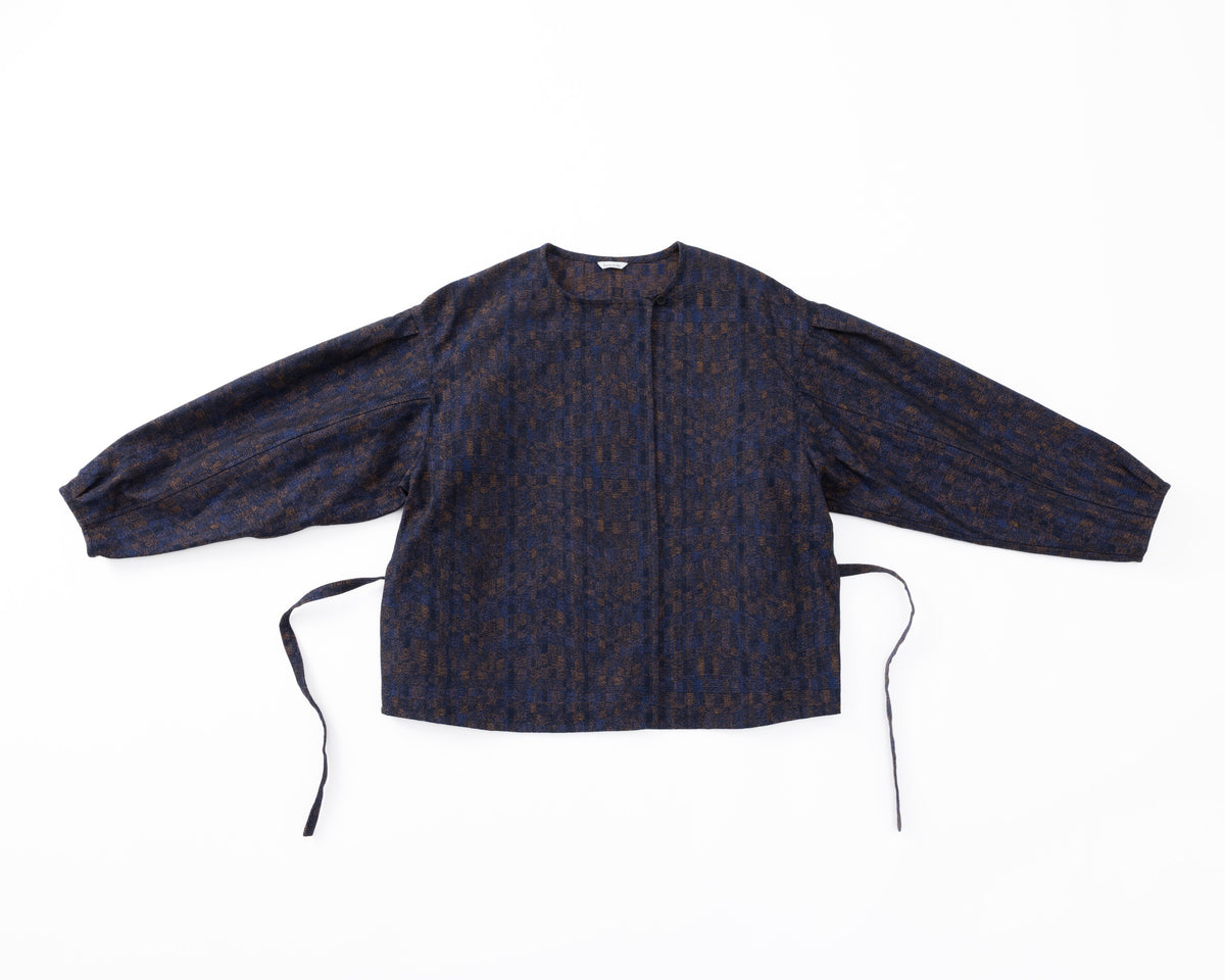 A navy shirt-jacket with a subtle pattern on a white background