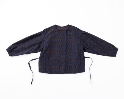A navy shirt-jacket with a subtle pattern on a white background