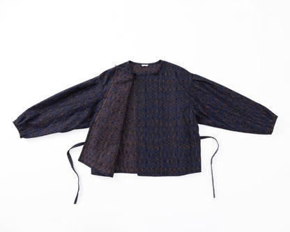 Dark patterned shirt with long sleeves on a white background