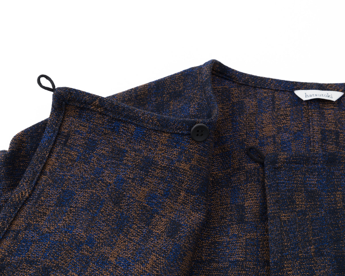 Close-up of a patterned garment with a brand label on a white background