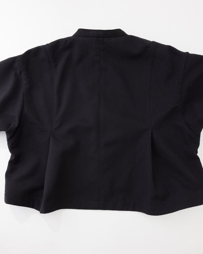 The back view of a black short-sleeve cropped jacket or blazer, laid flat against a white background.