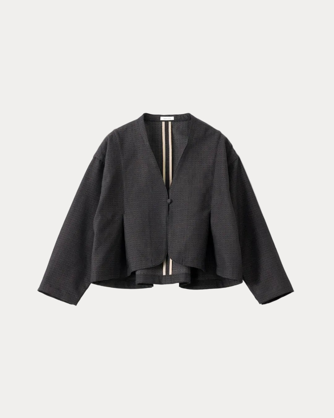 A black textured cropped jacket with long sleeves and a split V-neckline, featuring a vertical striped detail in beige and black down the centre front, displayed on a light grey background.