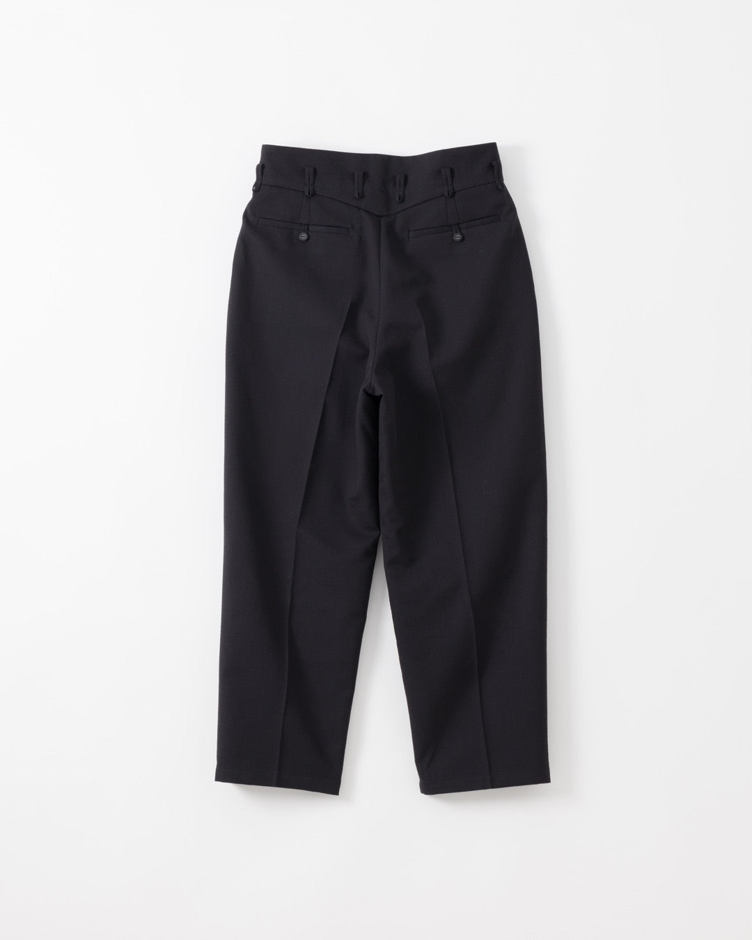 Black tailored trousers with a high waist, front pleats, and button details on the back waistband, shown flat against a light gray background.