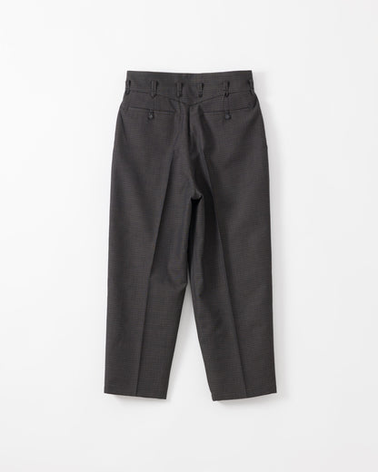 A pair of black trousers with a high waist, pleated front, and belt loops, laid flat against a white background.