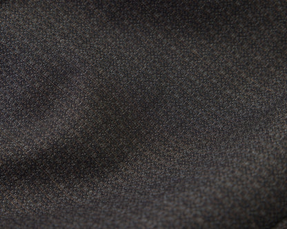 A close-up of black textured fabric with a fine woven pattern and soft folds.