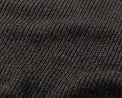 Close-up of a dark ribbed knit fabric with vertical ridges in black and brown tones.