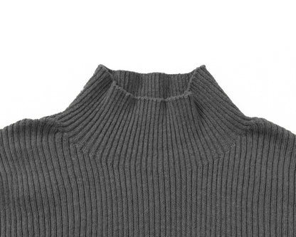 Close-up of a grey ribbed knit turtleneck sweater on a plain white background.