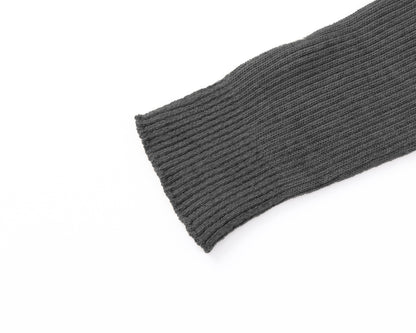 Close-up of a grey ribbed knit sleeve or cuff on a plain white background.
