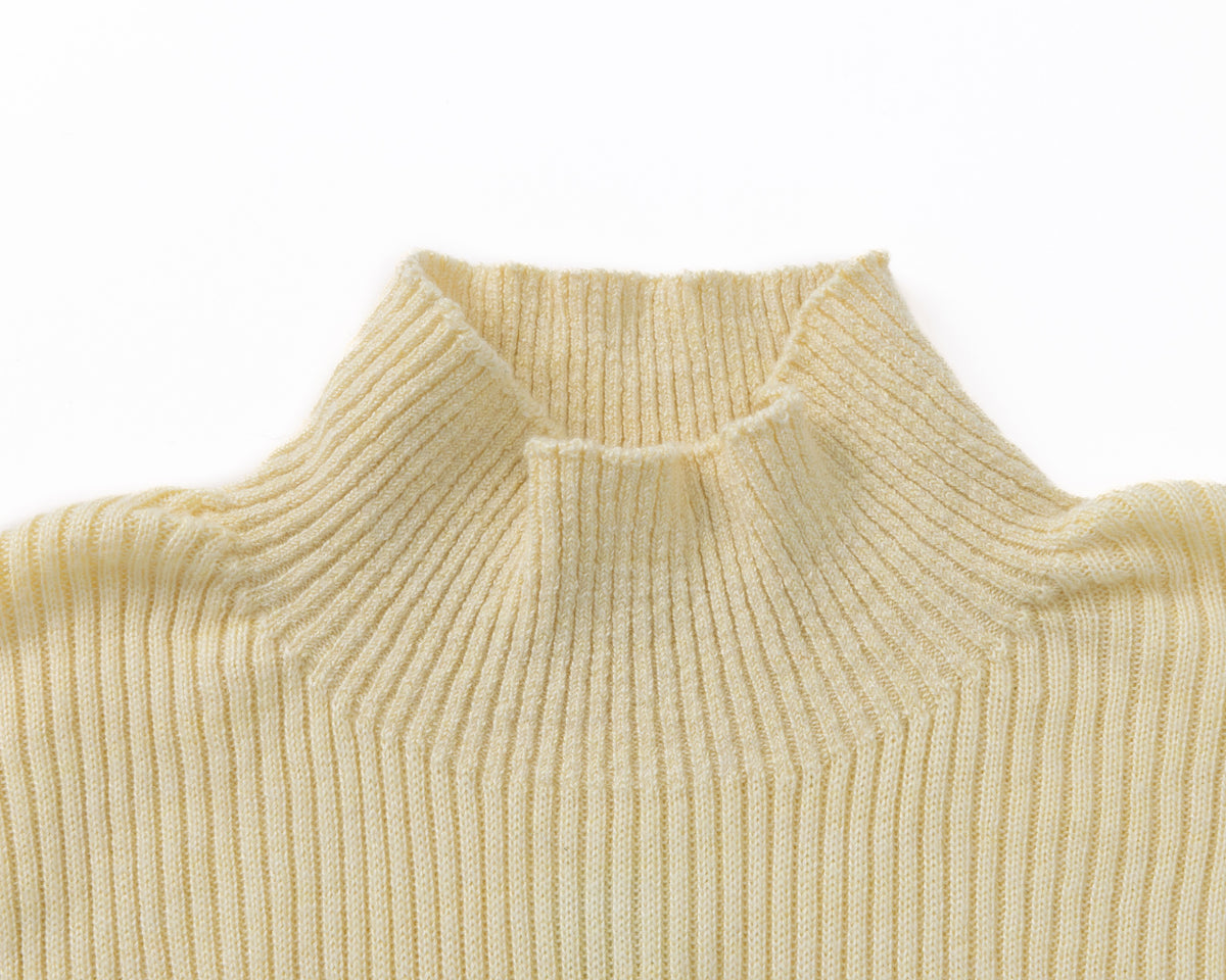 Close-up of a ribbed knit turtleneck sweater in a pale yellow colour, showing the texture and collar detail against a plain white background.