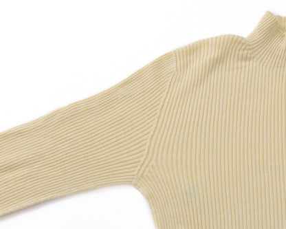 Close-up of a ribbed knit turtleneck sweater in a pale yellow colour, showing the texture and sleeve detail against a plain white background.