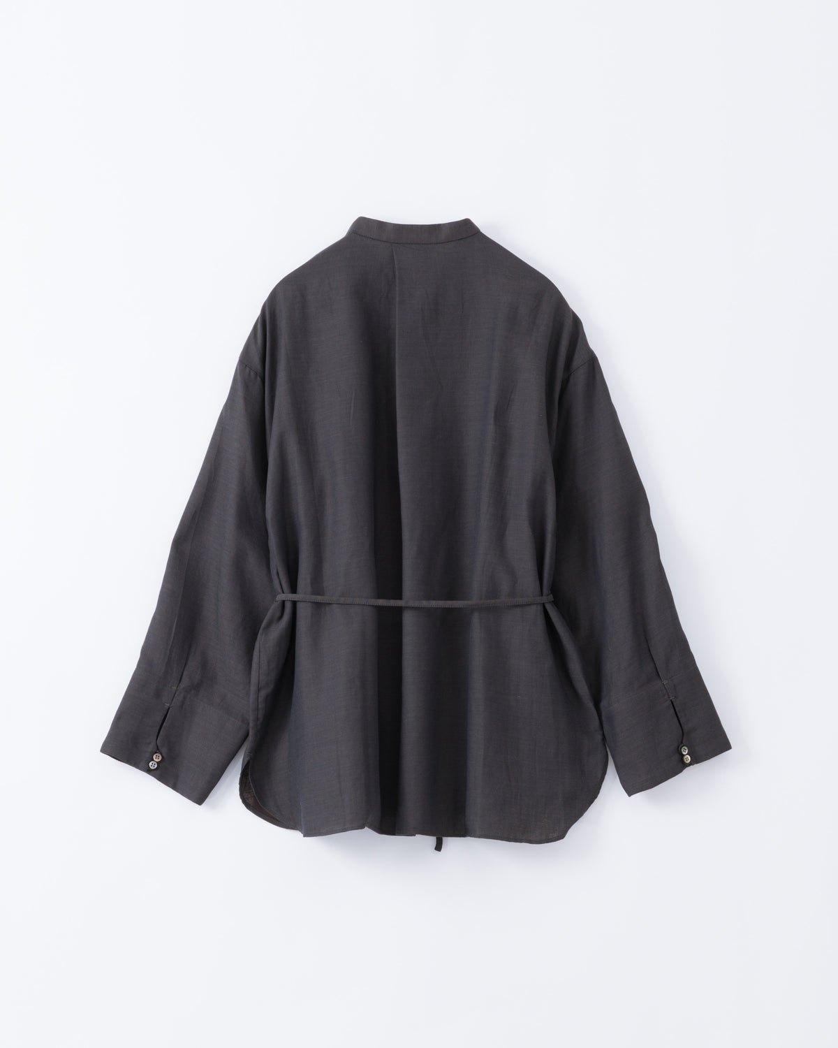 Back side of a black blouse with a belt on a white background