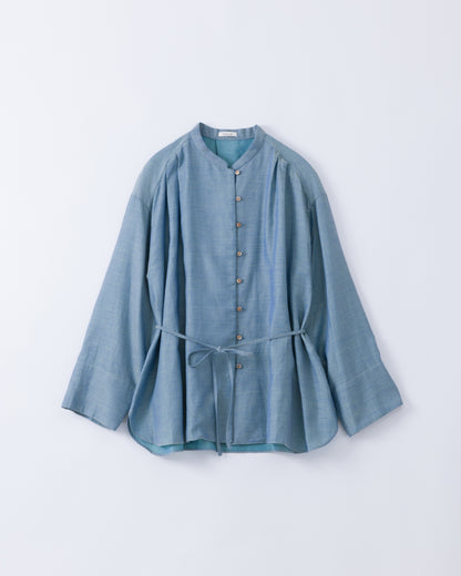 A light blue cotton long-sleeve top with a button-down front, mandarin collar, and a matching fabric tie belt at the waist, displayed flat against a light grey background.