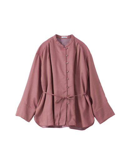 Pink cotton blouse with a belt on a light grey background