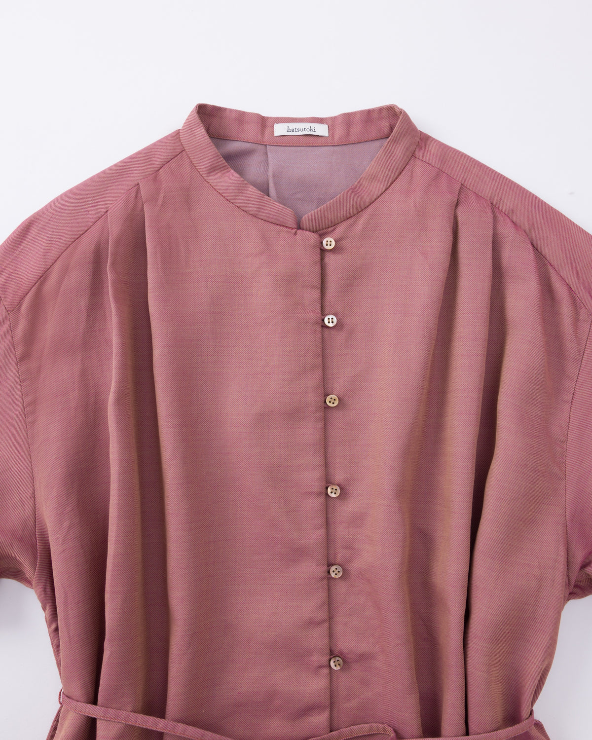 Pink blouse with short sleeves and buttons on a white background