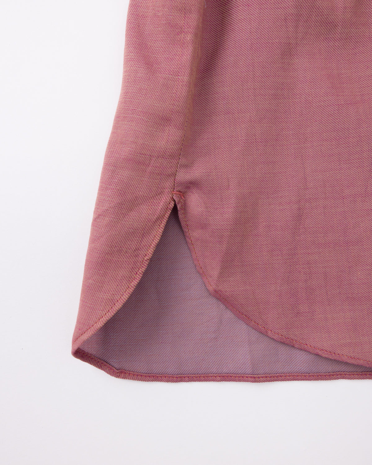 Close-up of a pink fabric with a textured pattern on a white background
