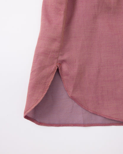 Close-up of a pink fabric with a textured pattern on a white background
