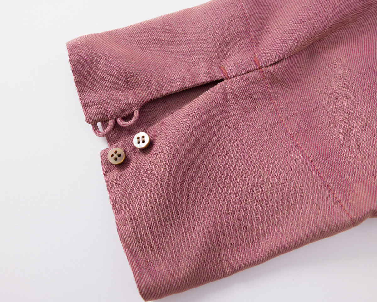 Close-up of a pink fabric with buttons on a white background