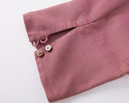 Close-up of a pink fabric with buttons on a white background