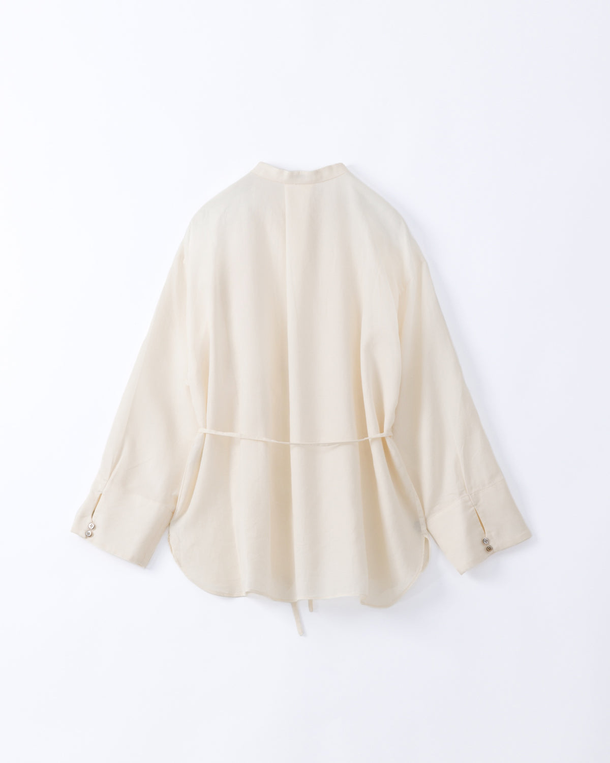 An off-white long-sleeve cotton shirt with a drawstring tie at the waist, displayed against a white background.