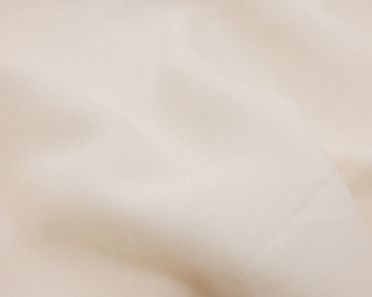 Close up of an off-white textured fabric