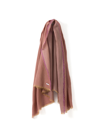 Dark pink scarf with purple and gold trims draped over a white background