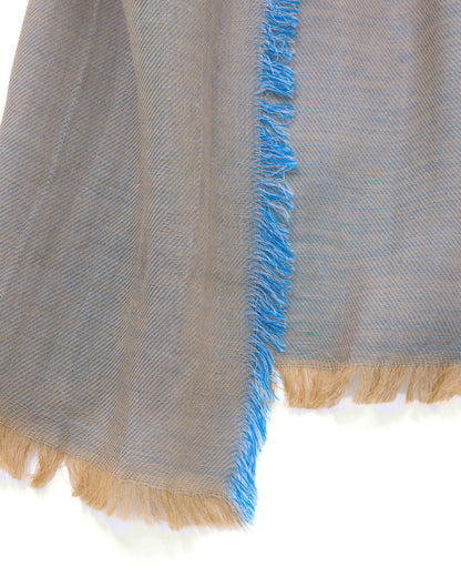 Textured fabric with blue fringe on a white background