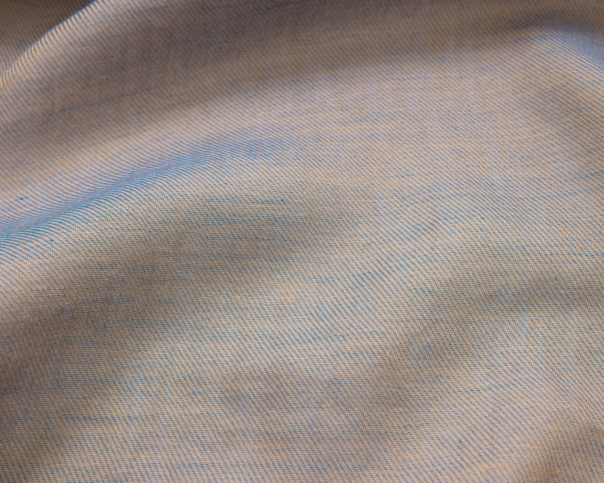 Close up of a grey textured fabric with blue accents