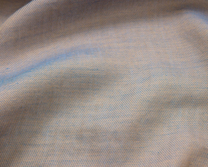 Close up of a grey textured fabric with blue accents