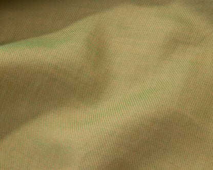Close up of a pistachio green textured fabric
