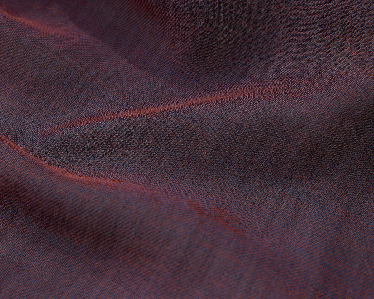 Close up of purple textured fabric with red accents