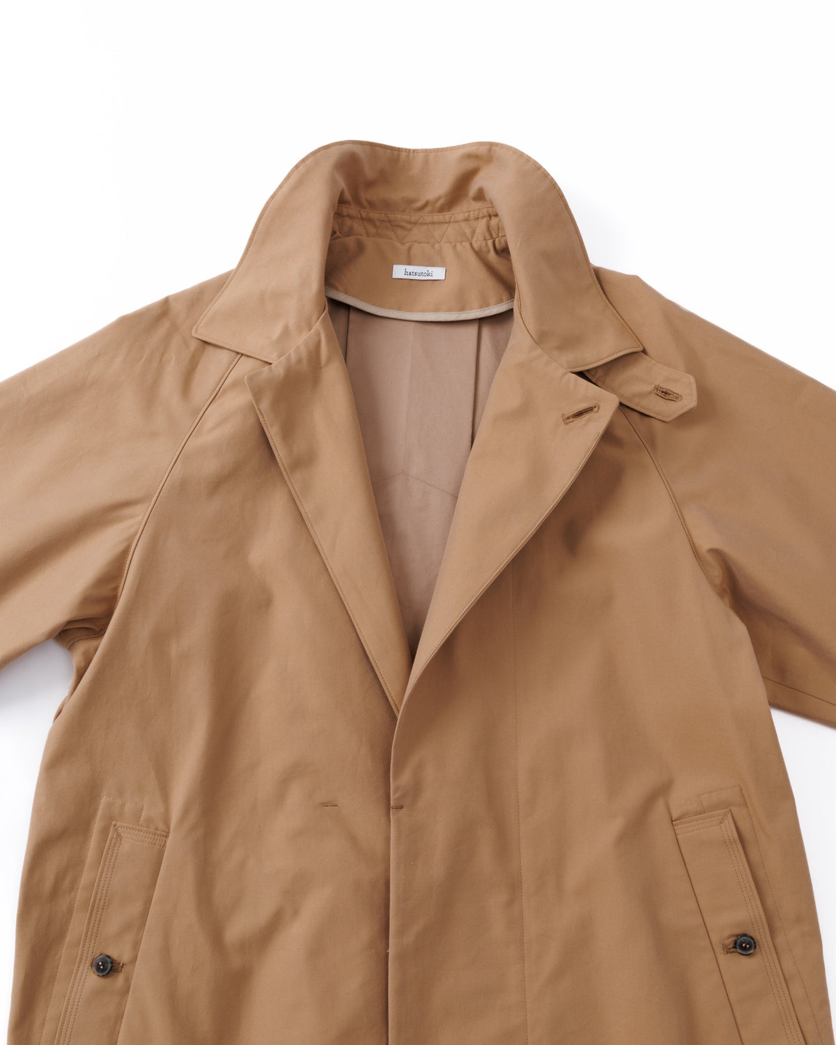Tan car coat, partially open, on a white background