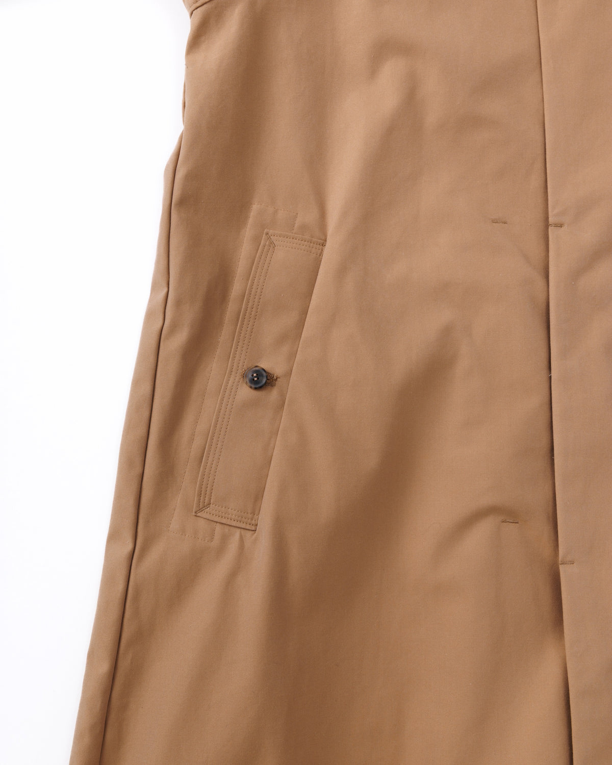 Close-up of a beige coat with a pocket on a white background