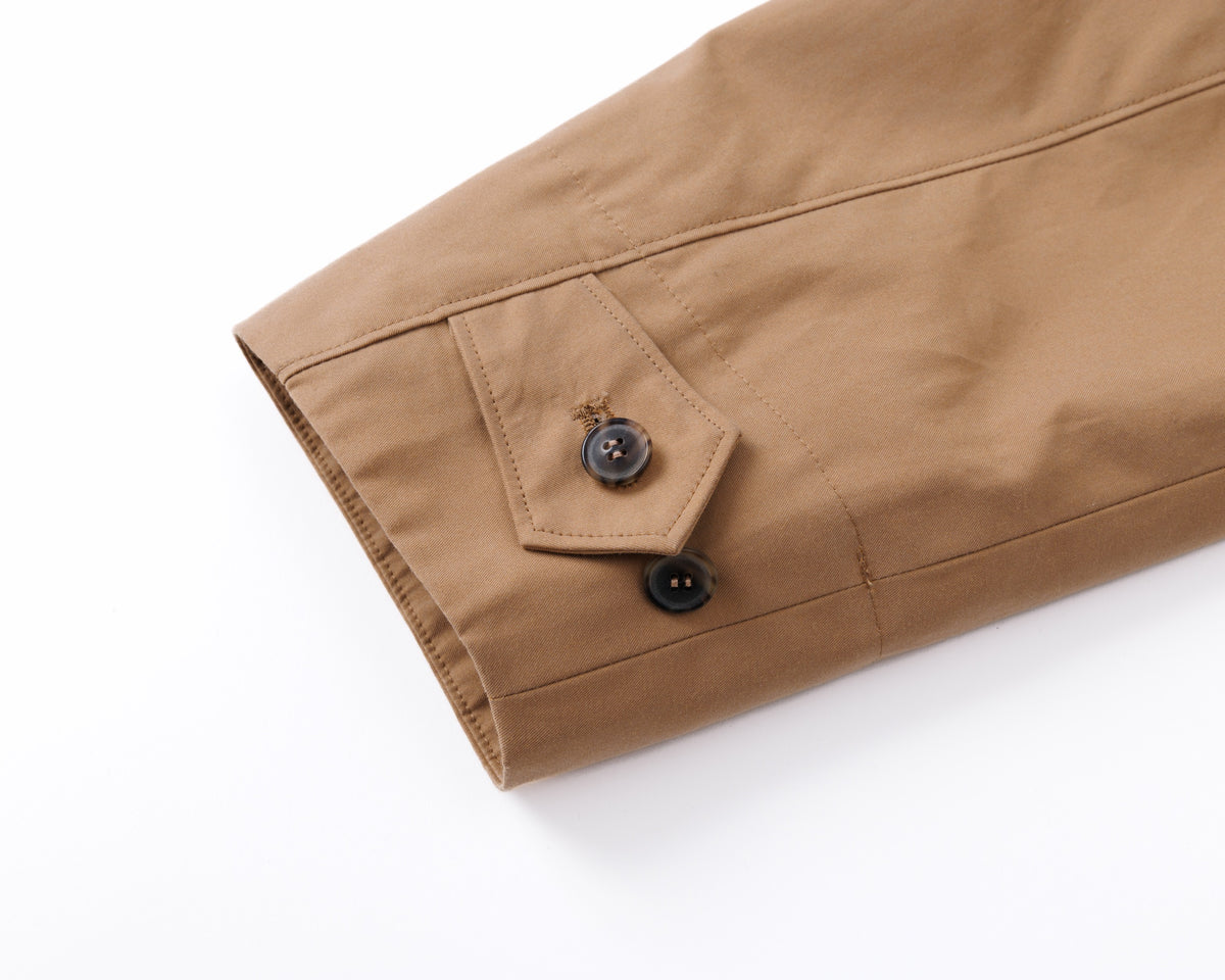 Close-up of a beige fabric with buttons on a white background