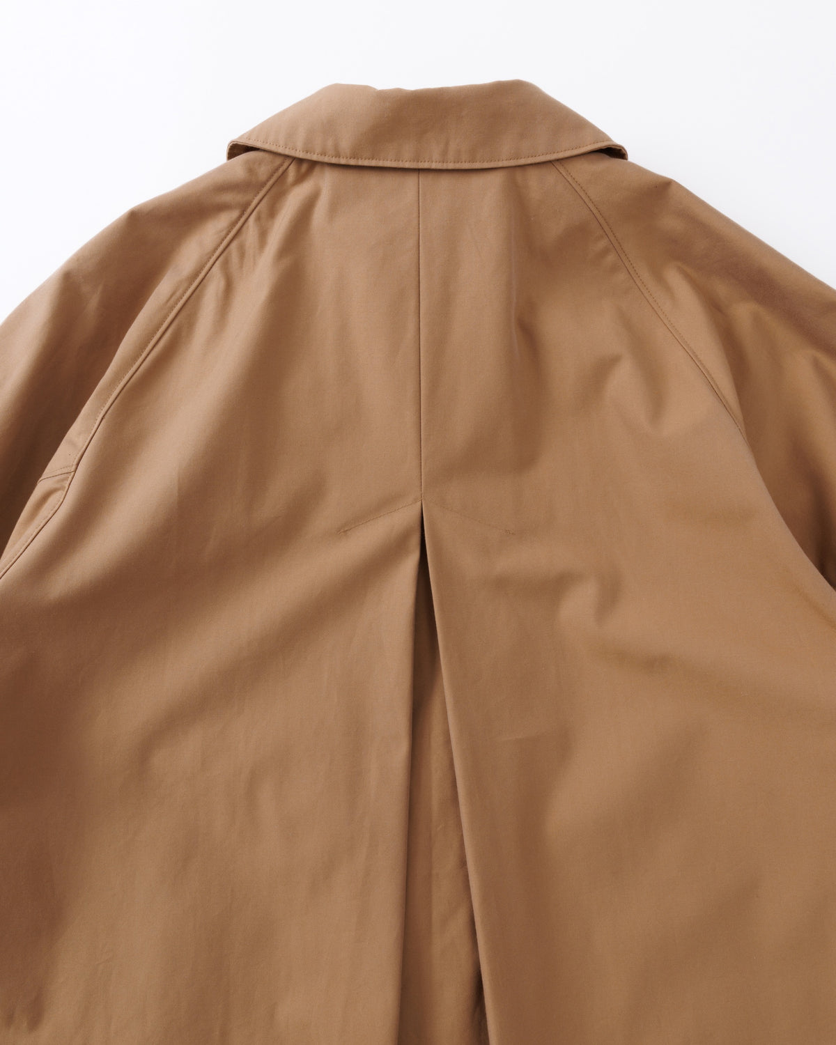 Close-up of a beige coat on a white background